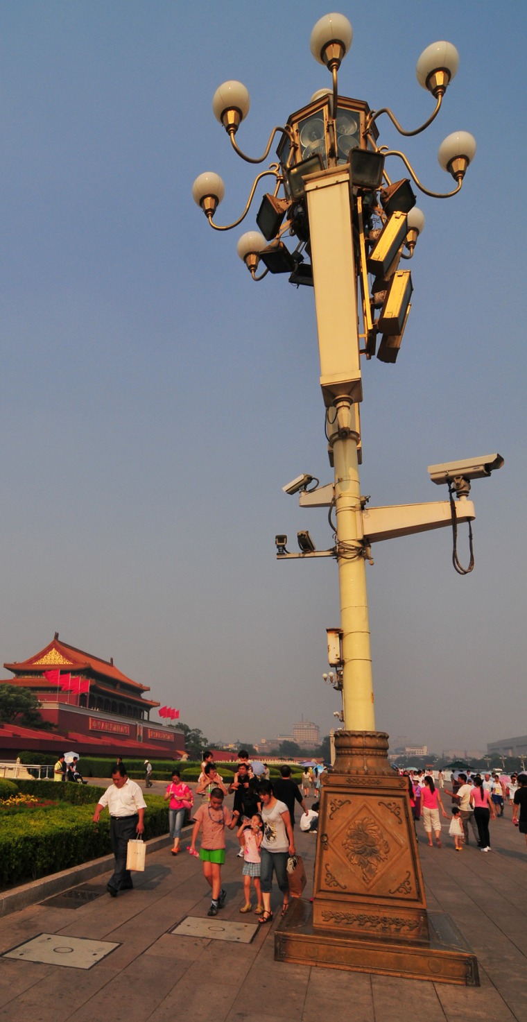 An ornate street light near Tiananmen Square doubles as a mount for security cameras.